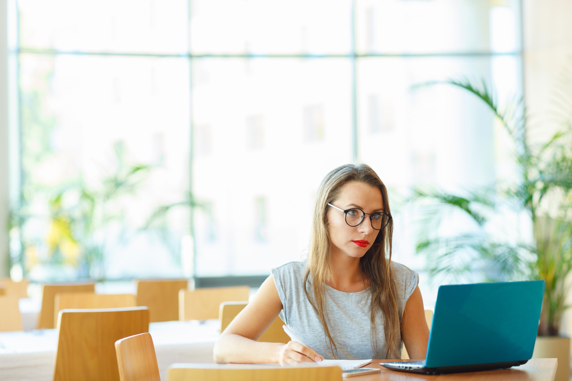 Business woman sitting in a cafe with a laptop